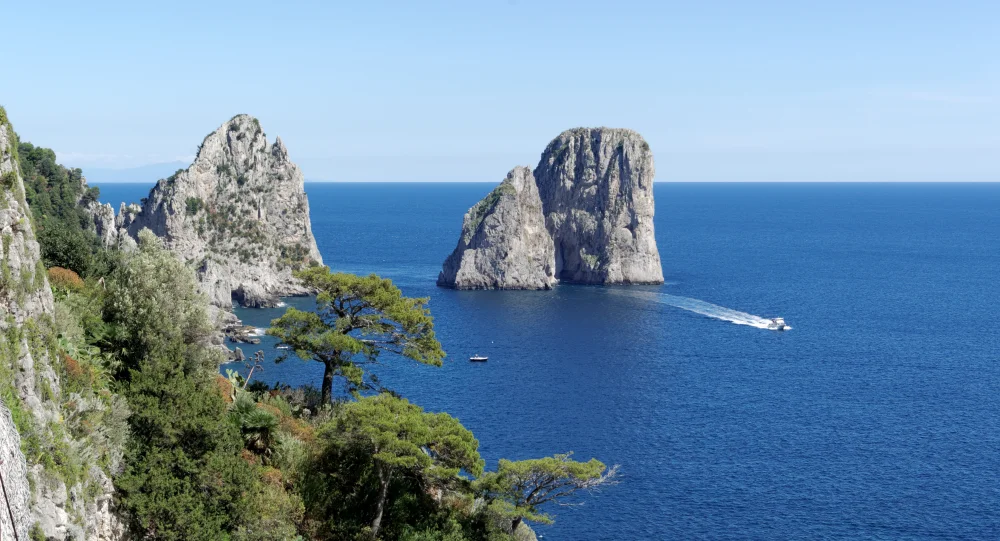 Bateau traditionnel devant les Faraglioni de Capri, mer Tyrrhénienne, Campanie
