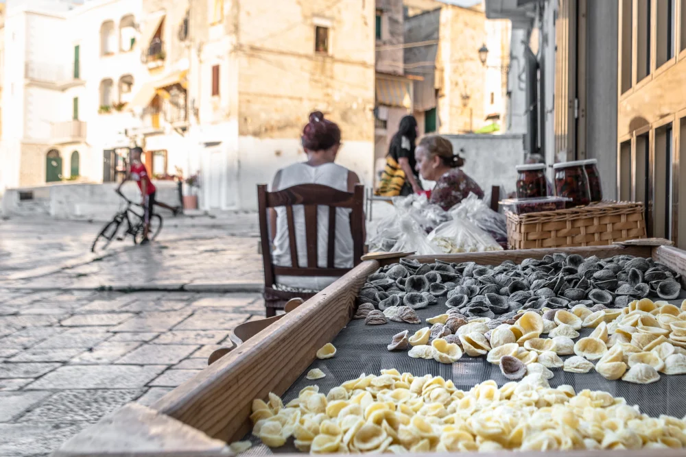 Femmes façonnant des orecchiette à la main devant leur porte, Via dell'Arco Basso, Bari Vecchia, Pouilles